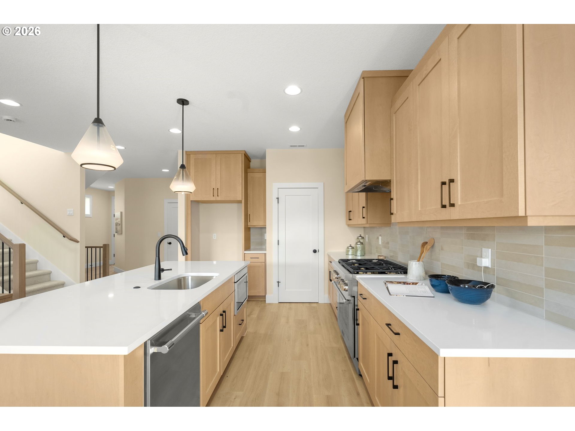 2876 Northwest 114th Terrace Portland, OR 97229 - Photo 6 of 32 a kitchen with kitchen island a sink a counter space and cabinets