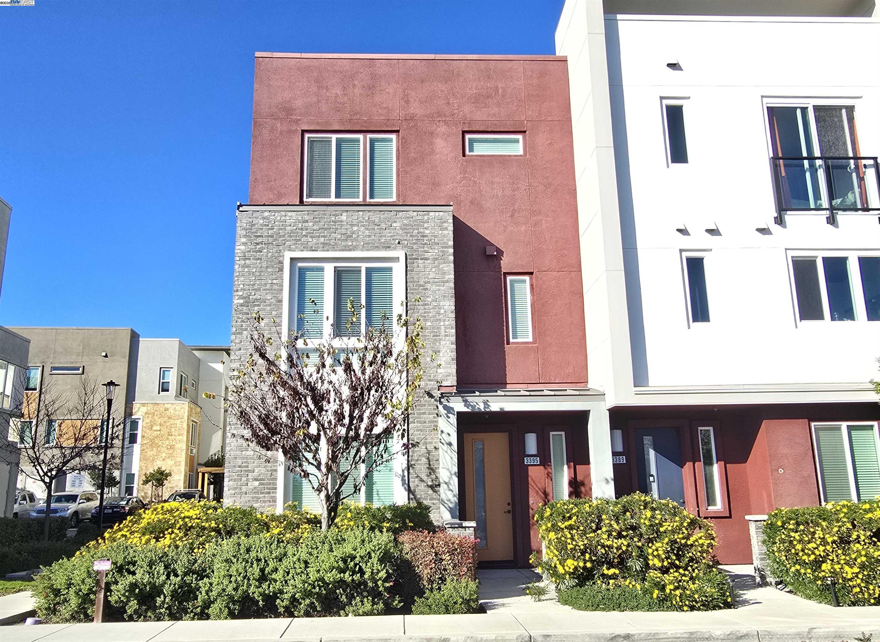 a front view of a building with a garden