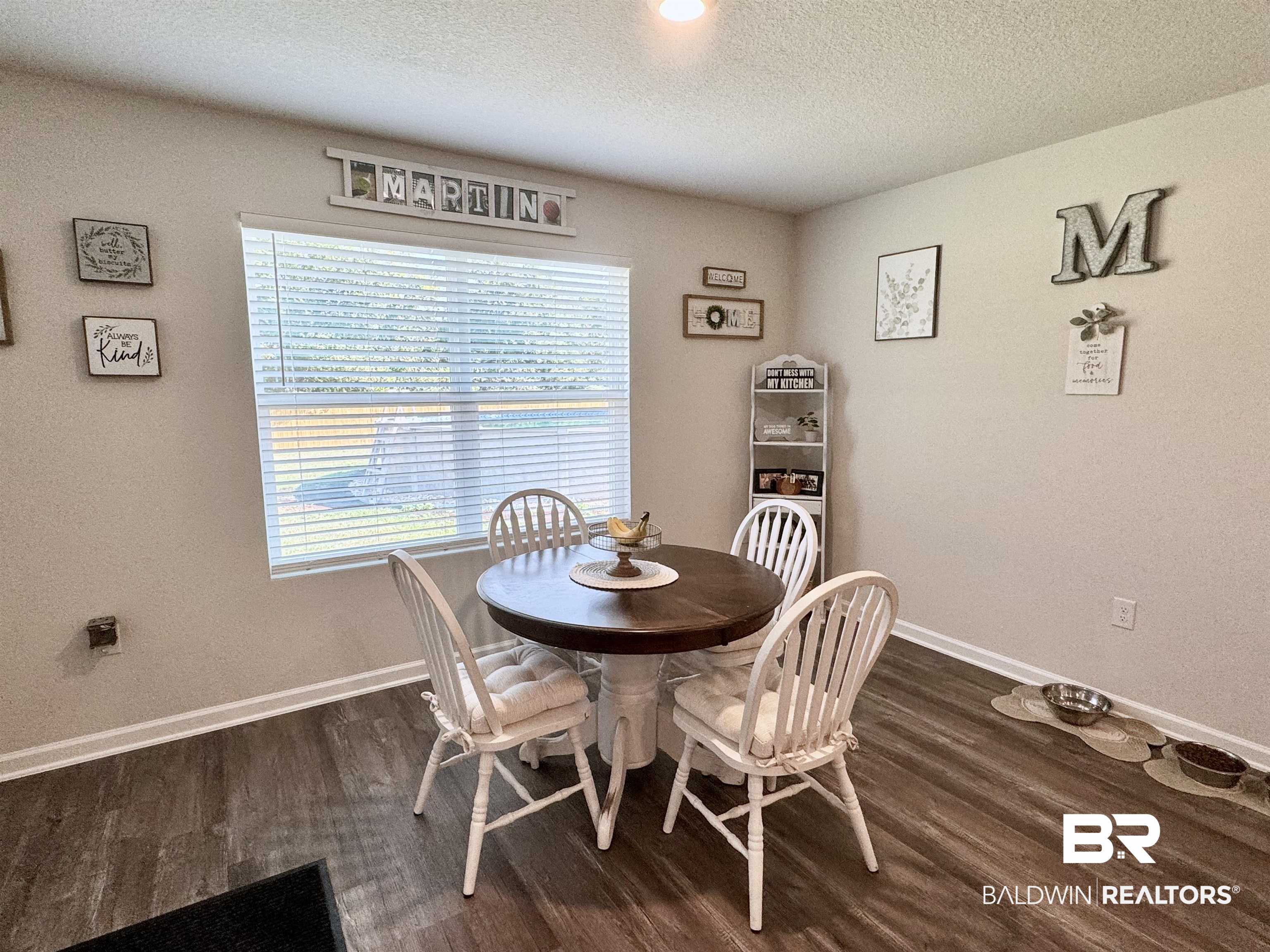 24216 Ringneck Loop Elberta, AL 36530 - Photo 22 of 23 Dining room with a textured ceiling and dark wood-style floors