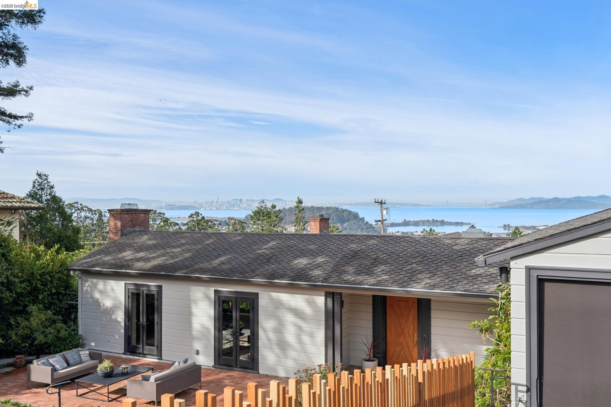 38 Highgate Road Kensington, CA 94707 - Photo 66 of 78 Expansive bay and city scenery, brick chimney, horizontal siding, black-framed French doors, and a wood privacy fence