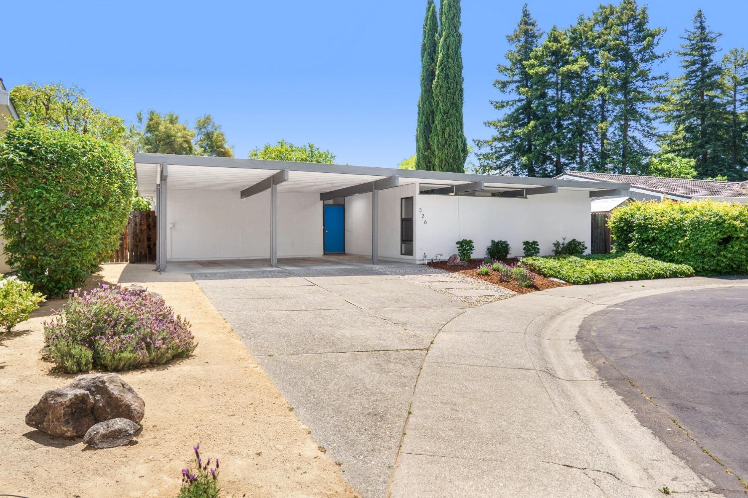 a front view of a house with a yard and a garage