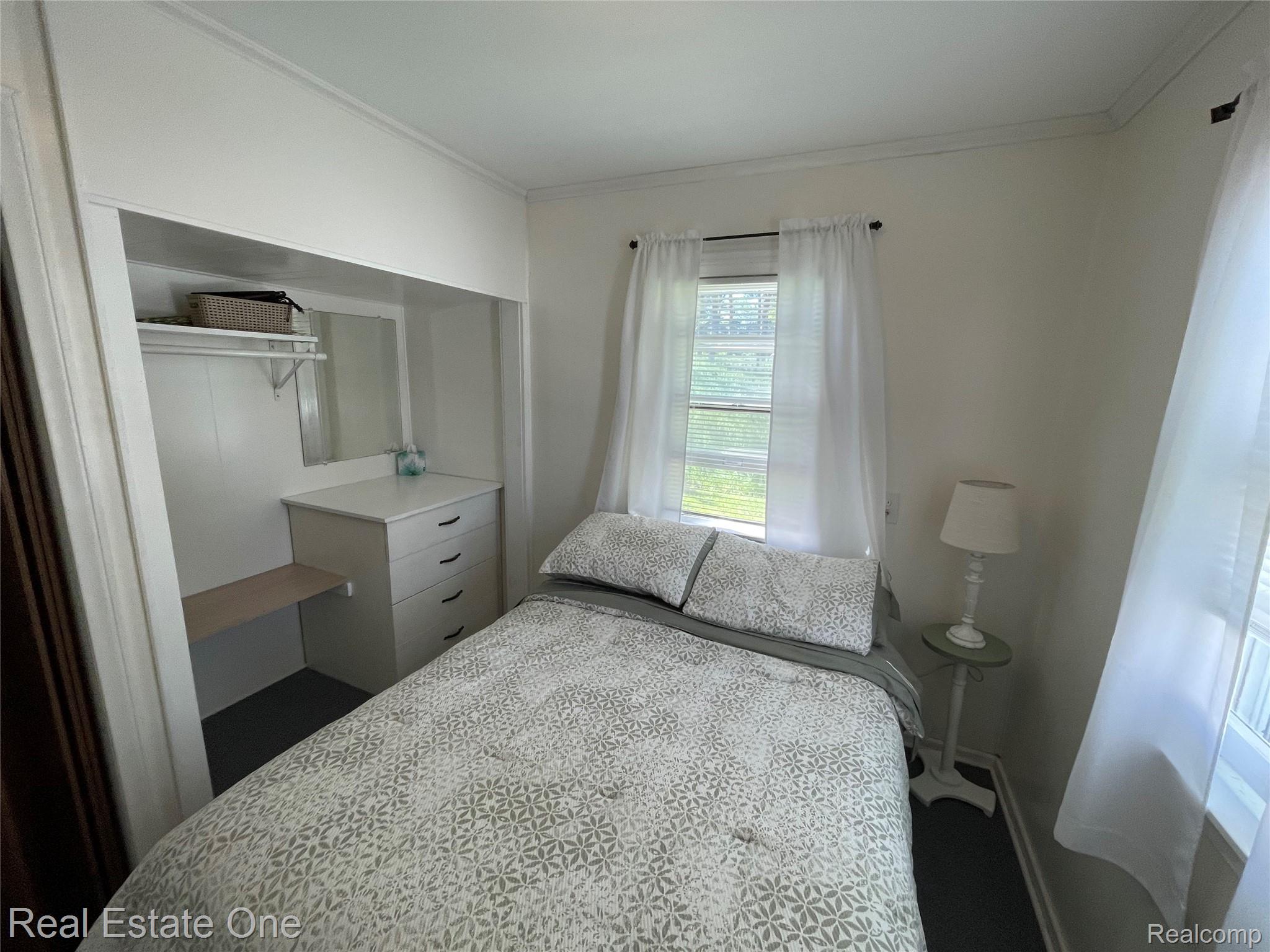 4160 Hawk Road Lincoln, MI 48742 - Photo 31 of 48 Recessed built-in dresser with four drawers and a dedicated shelf space, complemented by a wall-mounted mirror