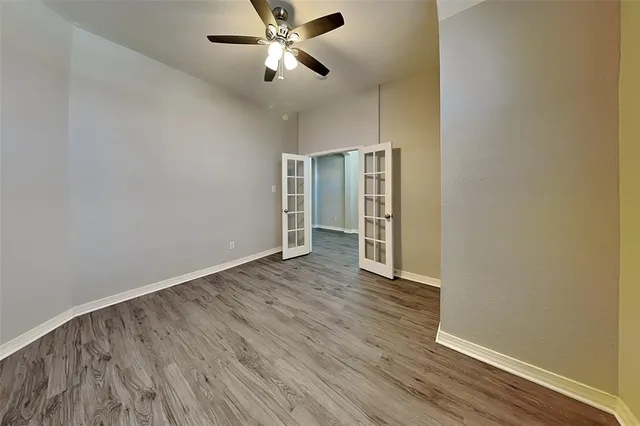 a view of empty room with wooden floor