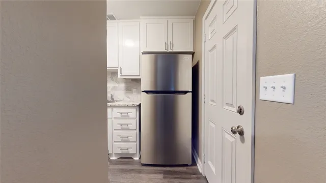 a view of walk in closet with empty racks