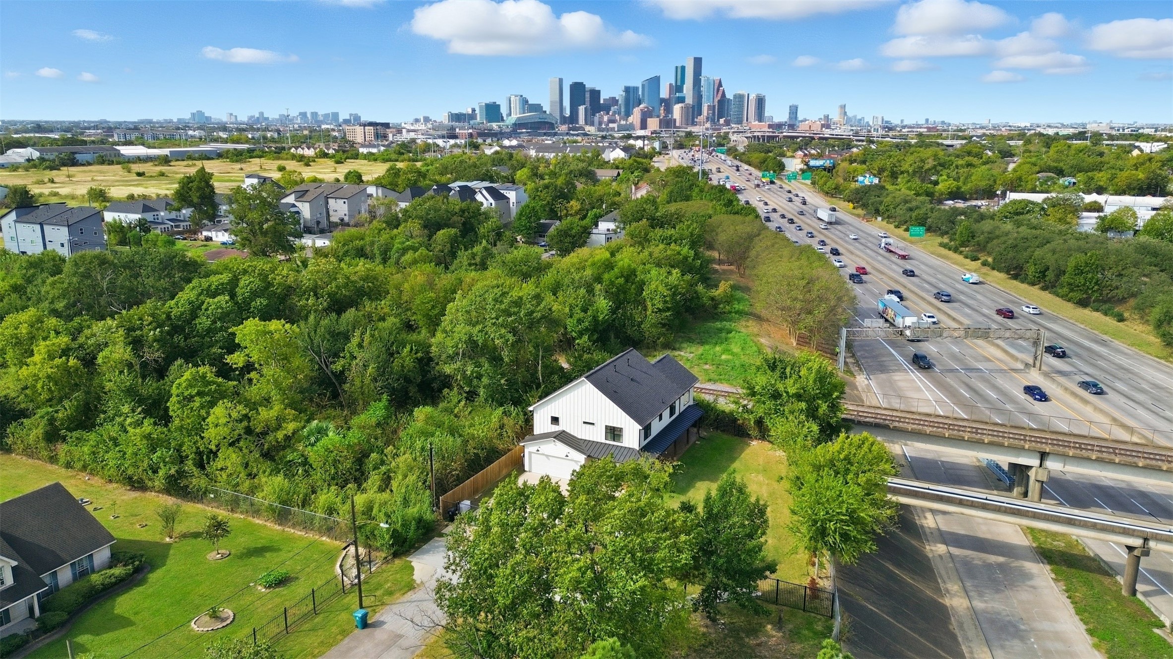 1018 Press Street Houston, TX 77020 - Photo 2 of 31 Aerial view showcasing the home’s prime location with the beautiful Houston skyline in the distance.
