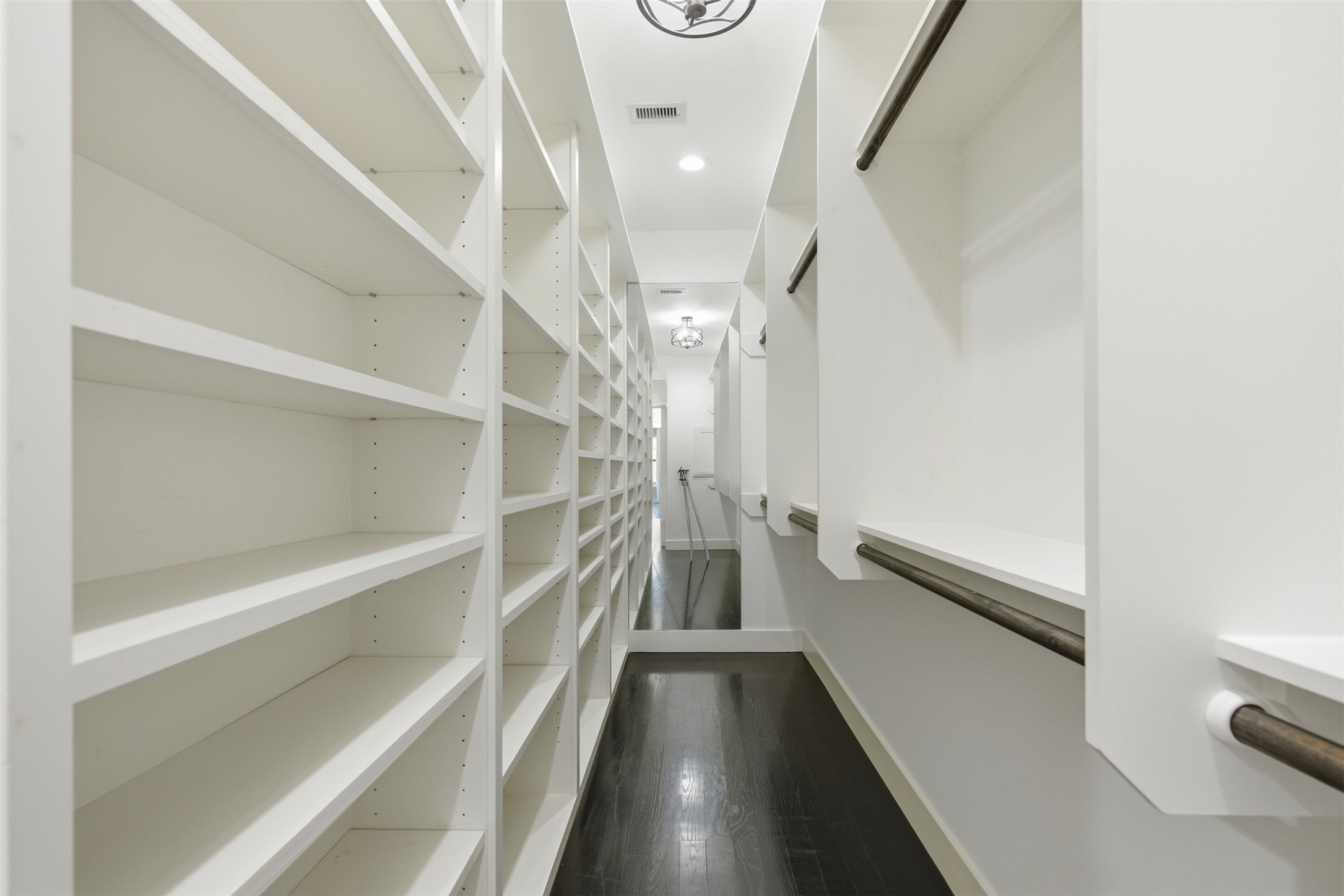 1018 Press Street Houston, TX 77020 - Photo 23 of 31 Large primary closet offers both style and storage with built-in shelves and generous hanging space.