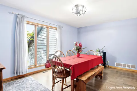 a view of a dining room with furniture window and wooden floor
