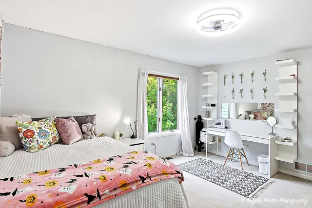 a bedroom with a bed and a window