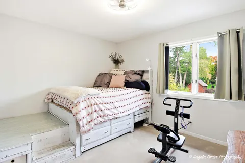 a bathroom with a sink a toilet and a window