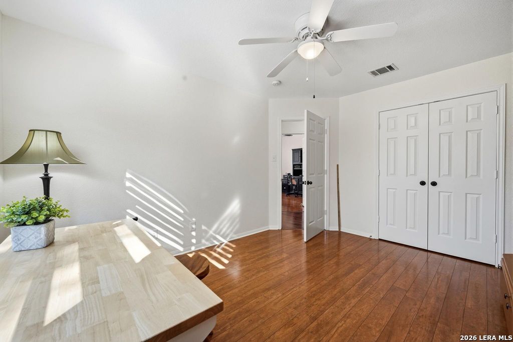 318 River Ridge Boerne, TX 78006 - Photo 30 of 46 a view of an empty room with wooden floor and a ceiling fan