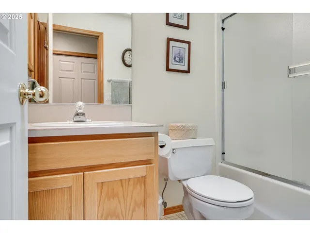 a bathroom with a granite countertop toilet sink and mirror