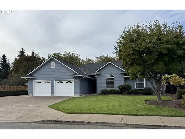 a front view of a house with a garden