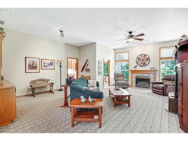 a living room with fireplace furniture and a fireplace