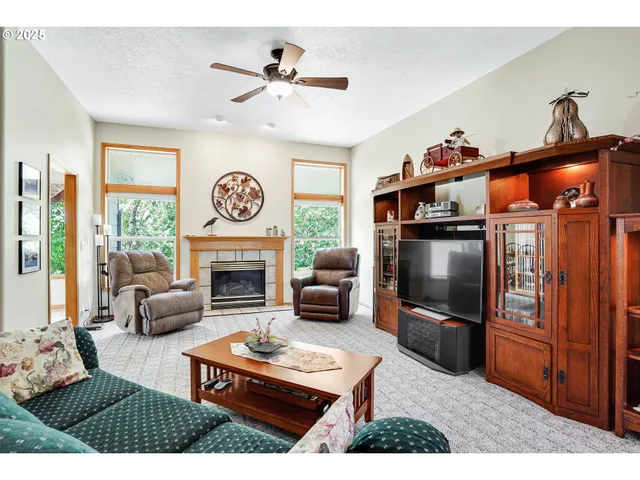 a living room with furniture a fireplace and a flat screen tv