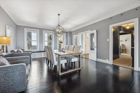 a view of a dining room with furniture window and wooden floor