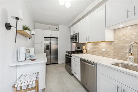 a kitchen with a sink stove and refrigerator