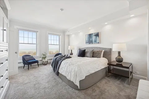 a spacious bedroom with a bed and a window