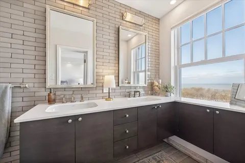 a bathroom with a tub sink and window