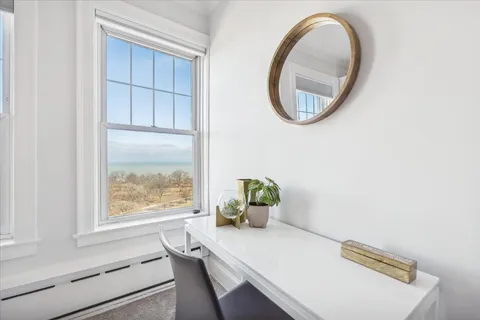 a room with white cabinets and wooden floor