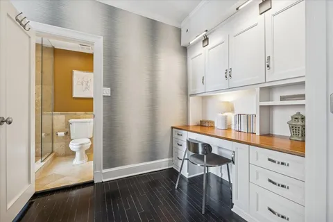 a bathroom with a granite countertop toilet sink and mirror