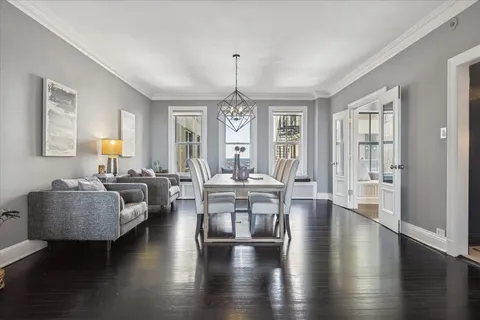 a living room with couches a table and chairs