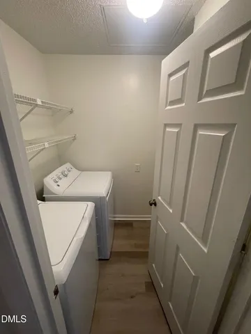 a view of walk in closet with wooden floor and cabinet