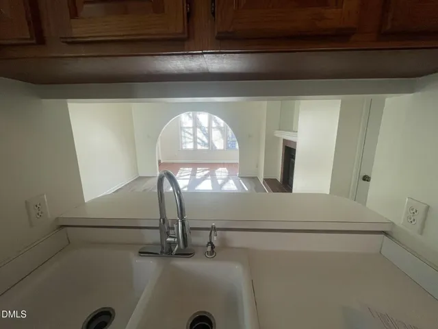 a kitchen with a refrigerator sink and white cabinets