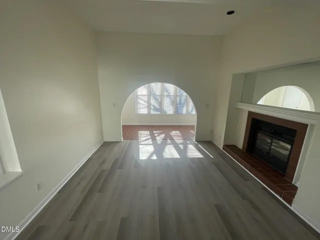 wooden floor in an empty room with a fireplace