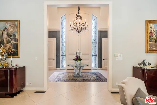 a living room with fireplace furniture and a chandelier