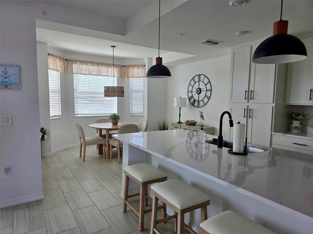 19116 Scallop Loop, Unit 303 Lakewood Ranch, FL 34211 - Photo 5 of 32 a kitchen with stainless steel appliances granite countertop a sink a stove and a wooden floors