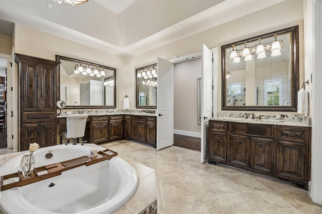 1005 Berkshire Road Southlake, TX 76092 - Photo 26 of 40 a large bathroom with a double vanity sink large mirror and a bathtub