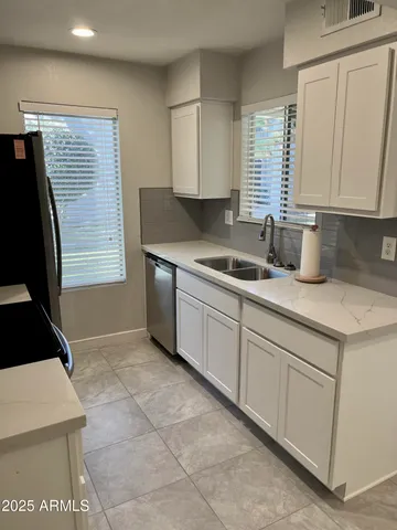 a kitchen with a sink and a refrigerator