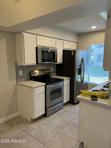 a kitchen with stainless steel appliances a stove microwave and refrigerator