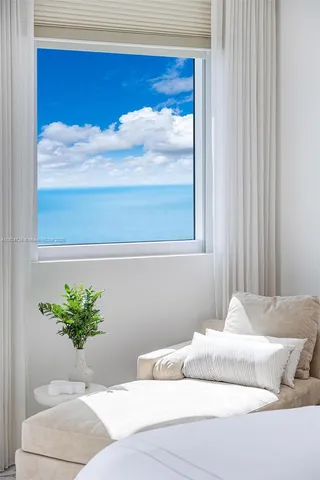 a bedroom with a bed and a lamp