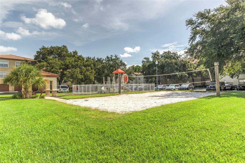 823 Camargo Way, Unit 101 Altamonte Springs, FL 32714 - Photo 19 of 20 a view of a swimming pool with a yard and a large tree