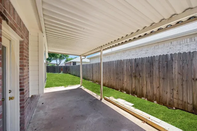 a view of a backyard with wooden fence