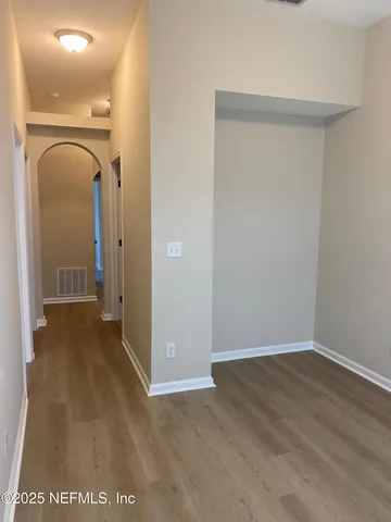 a view of a room with wooden floor