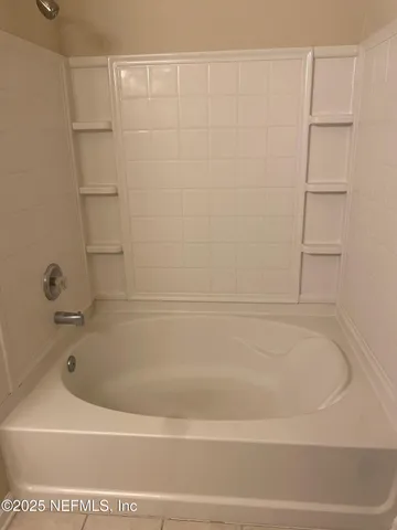 a close view of a bathtub in bathroom