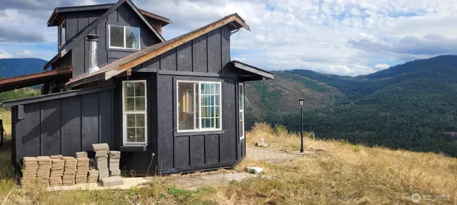 a view of backyard of house with green space