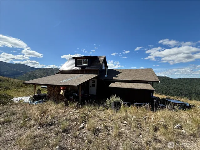 a view of a patio with table and chairs with wooden floor and a potted plant