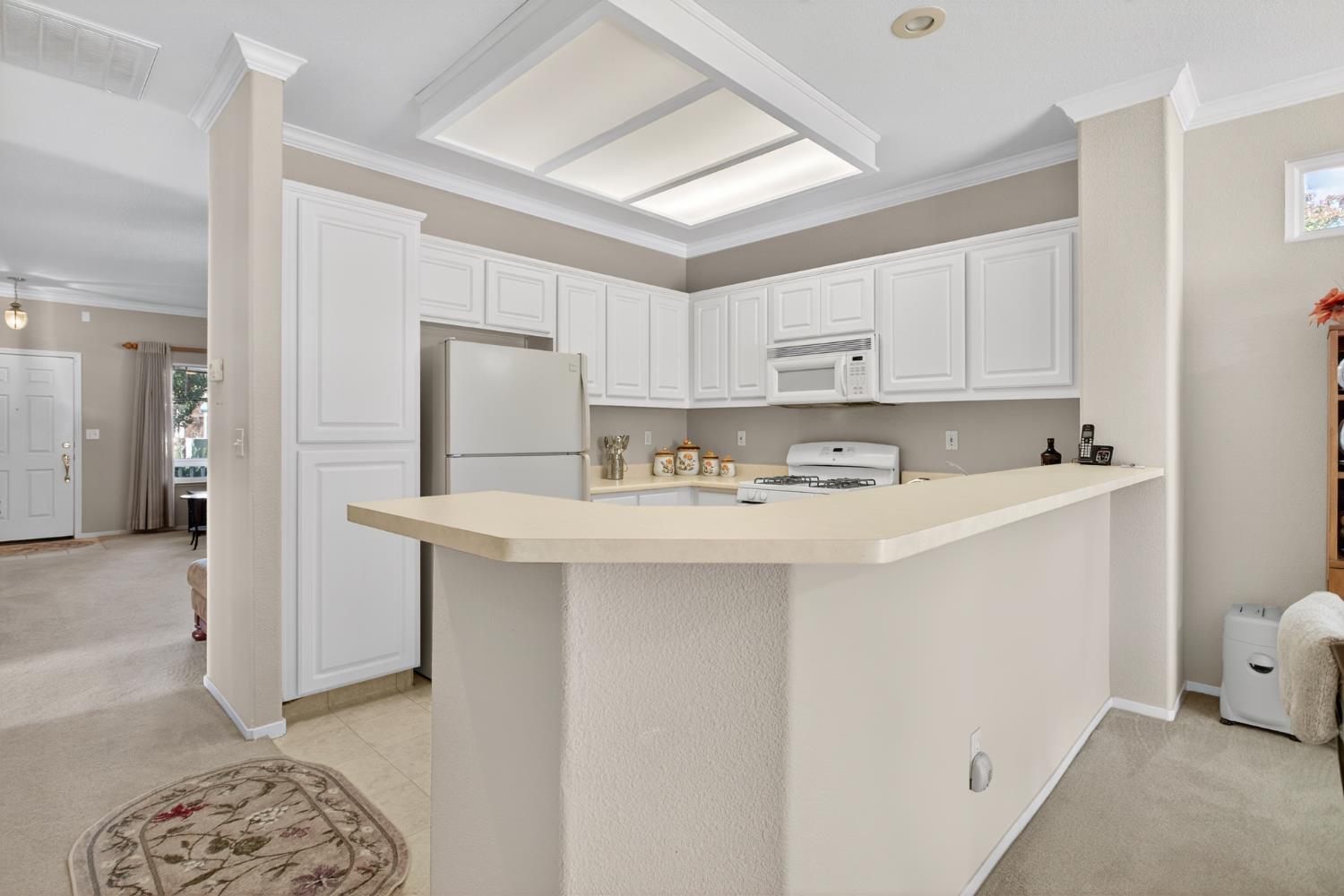 3200 Spring Garden Drive Turlock, CA 95382 - Photo 12 of 30 a kitchen with stainless steel appliances granite countertop a sink a refrigerator a stove a microwave and white cabinets