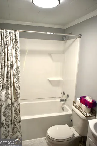 a bathroom with a toilet and a bath tub