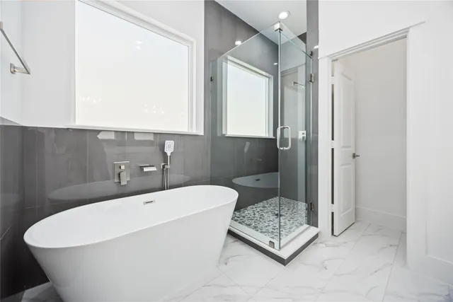 a bathroom with a bathtub and a shower