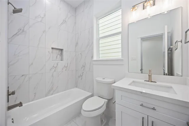 a bathroom with a sink a toilet and a bathtub