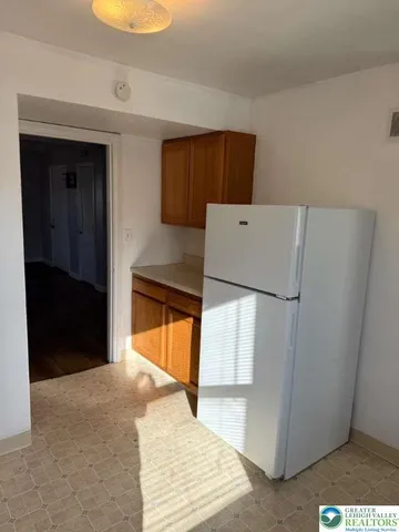 a refrigerator freezer sitting inside of a kitchen