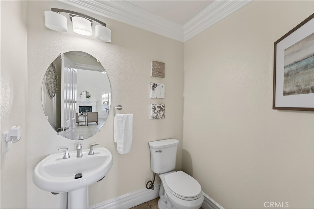 2634 Old Windmill Court Riverside, CA 92503 - Photo 11 of 44 a bathroom with a toilet a sink and mirror