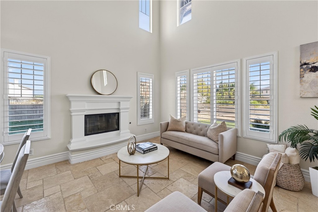 2634 Old Windmill Court Riverside, CA 92503 - Photo 14 of 44 a living room with furniture a fireplace and a large window