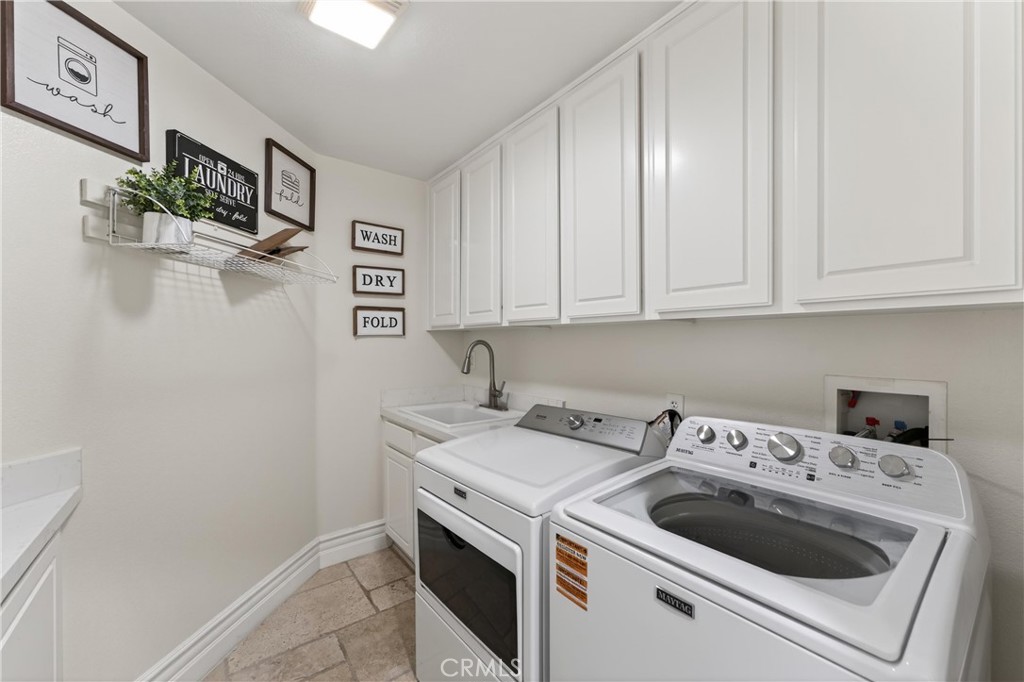 2634 Old Windmill Court Riverside, CA 92503 - Photo 22 of 44 a view of a storage and utility room with washer and dryer