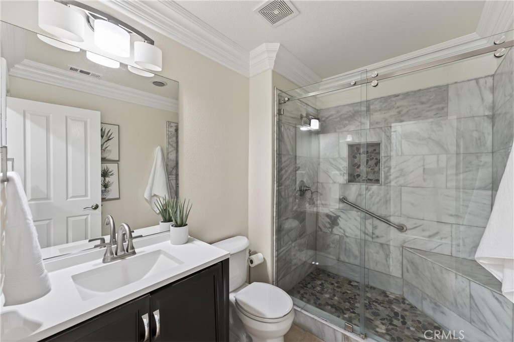 2634 Old Windmill Court Riverside, CA 92503 - Photo 24 of 44 a bathroom with a sink mirror toilet and shower