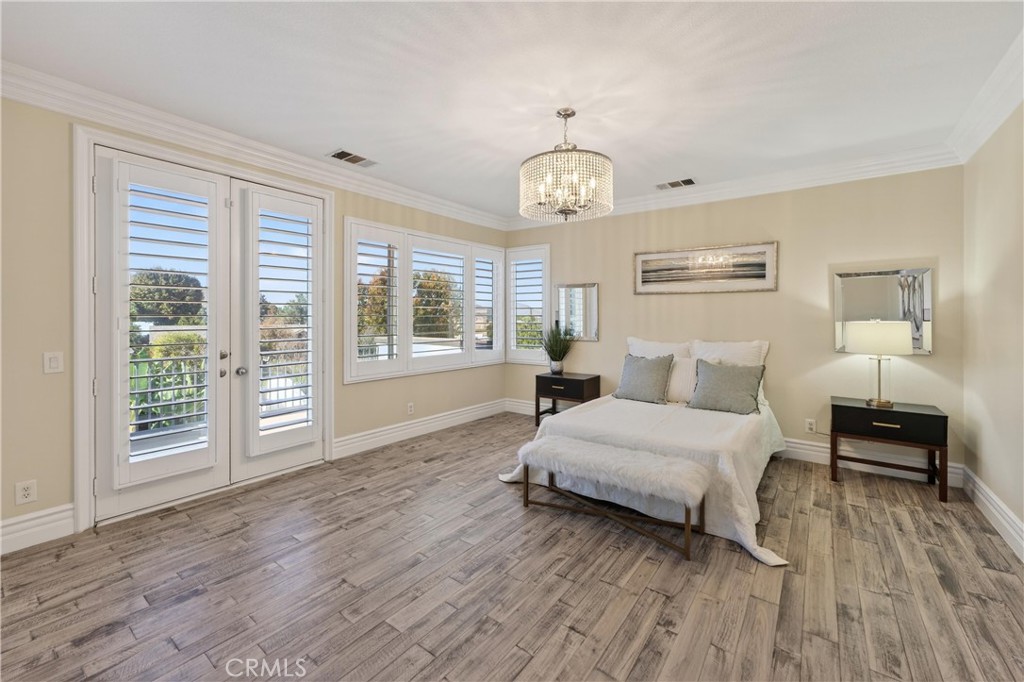 2634 Old Windmill Court Riverside, CA 92503 - Photo 27 of 44 a spacious bedroom with a bed and wooden floor